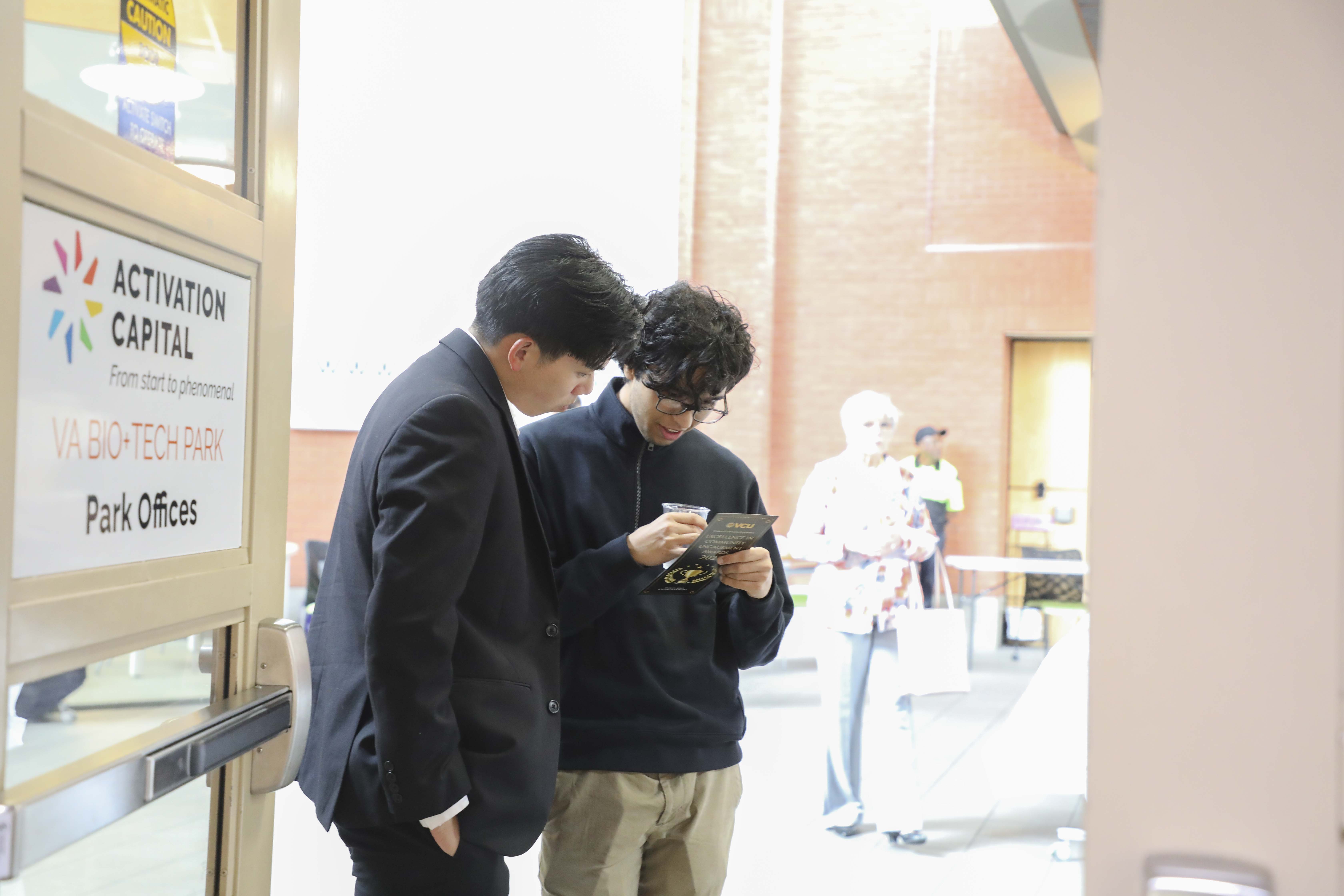 VCU Students reading a program