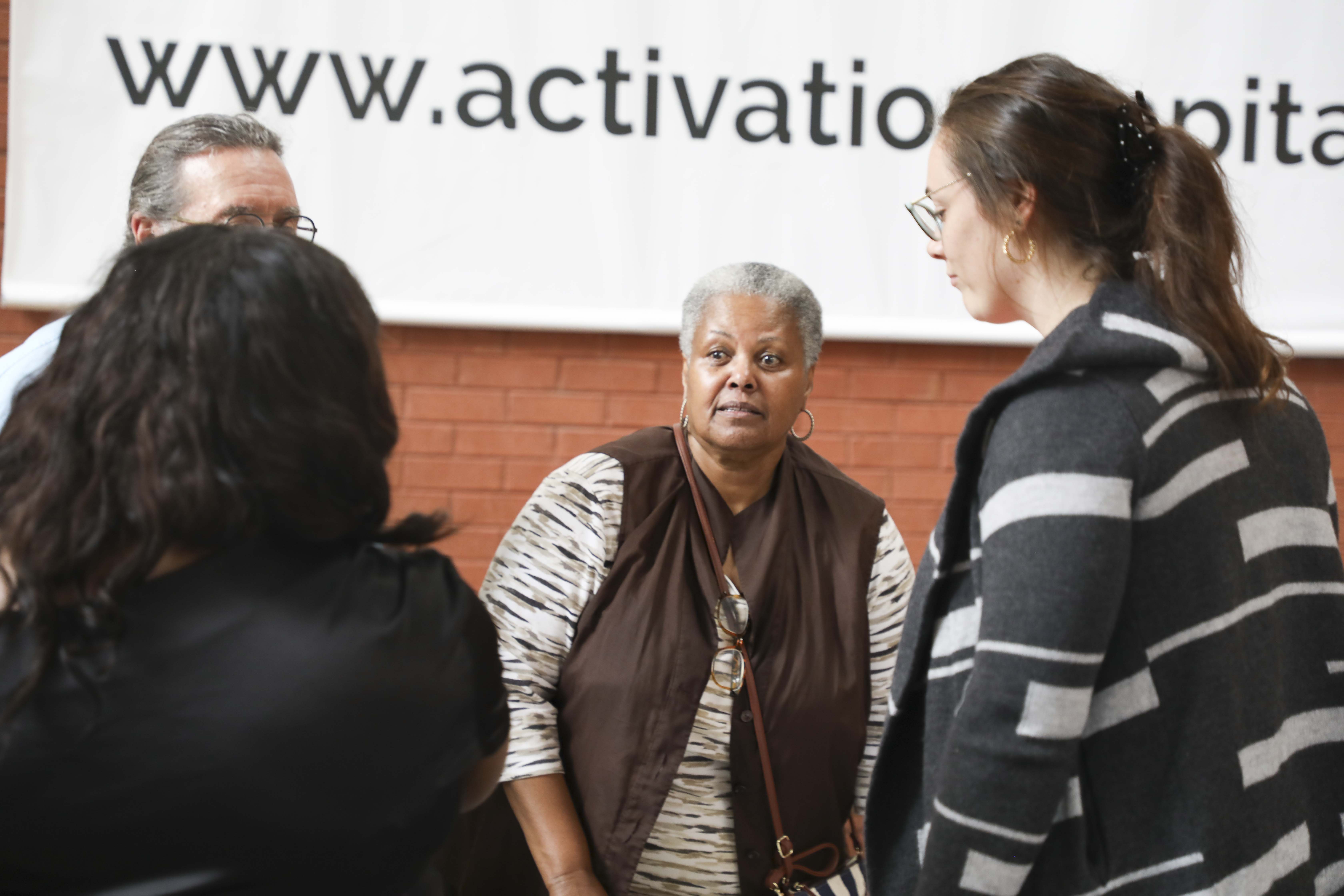 woman standing talking to people