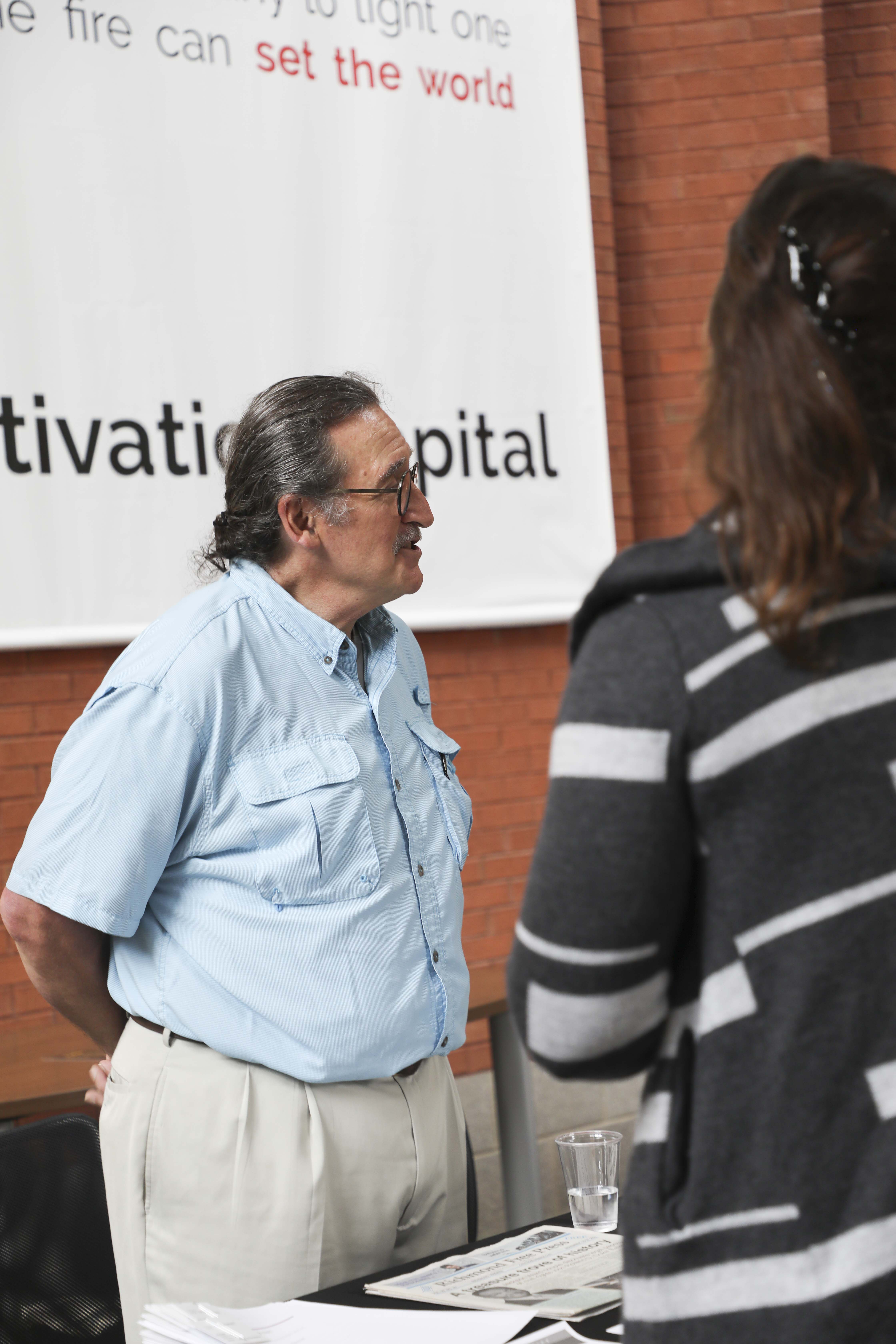 man talking to people