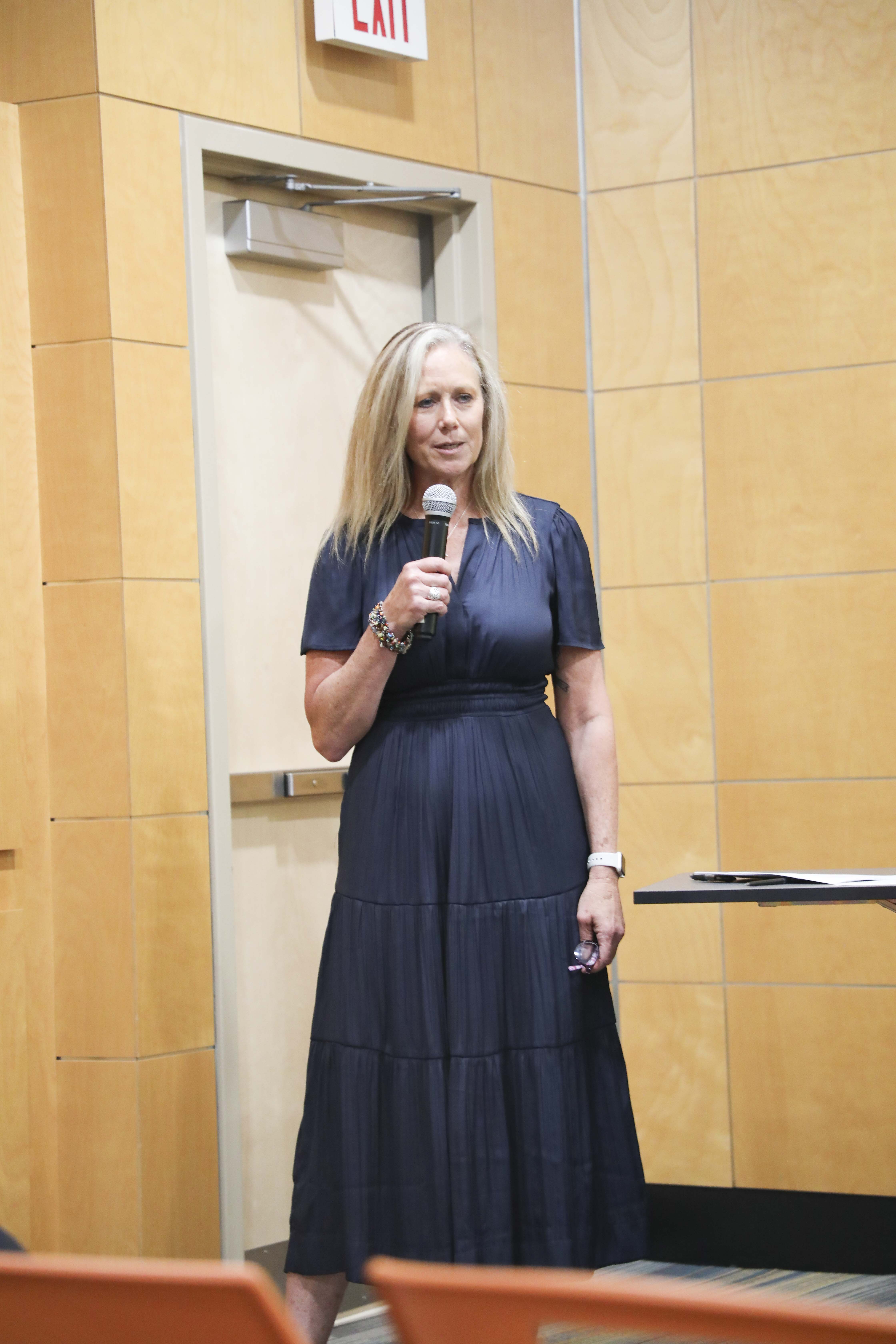 woman talking into a microphone