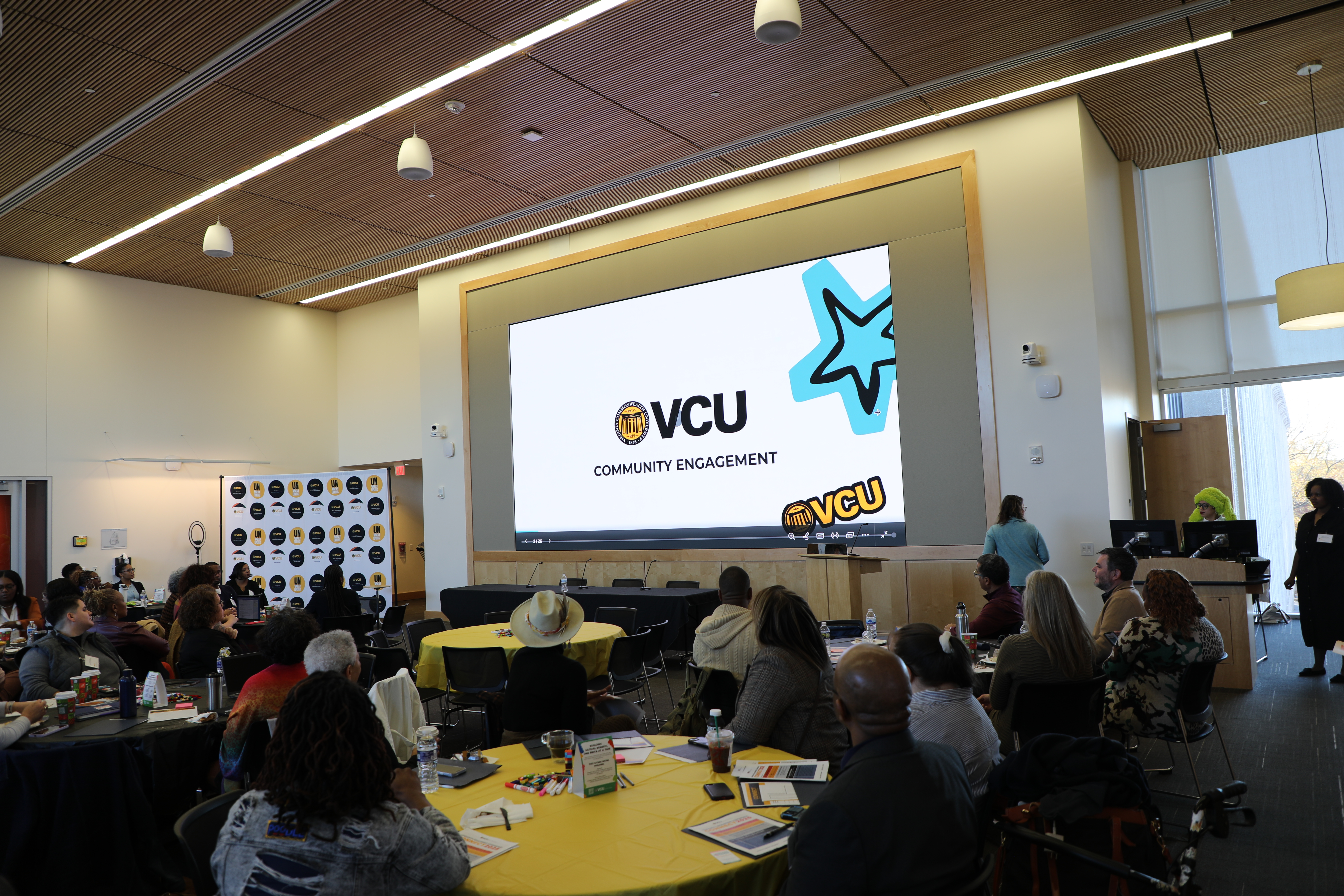 A group of people looking at a screen