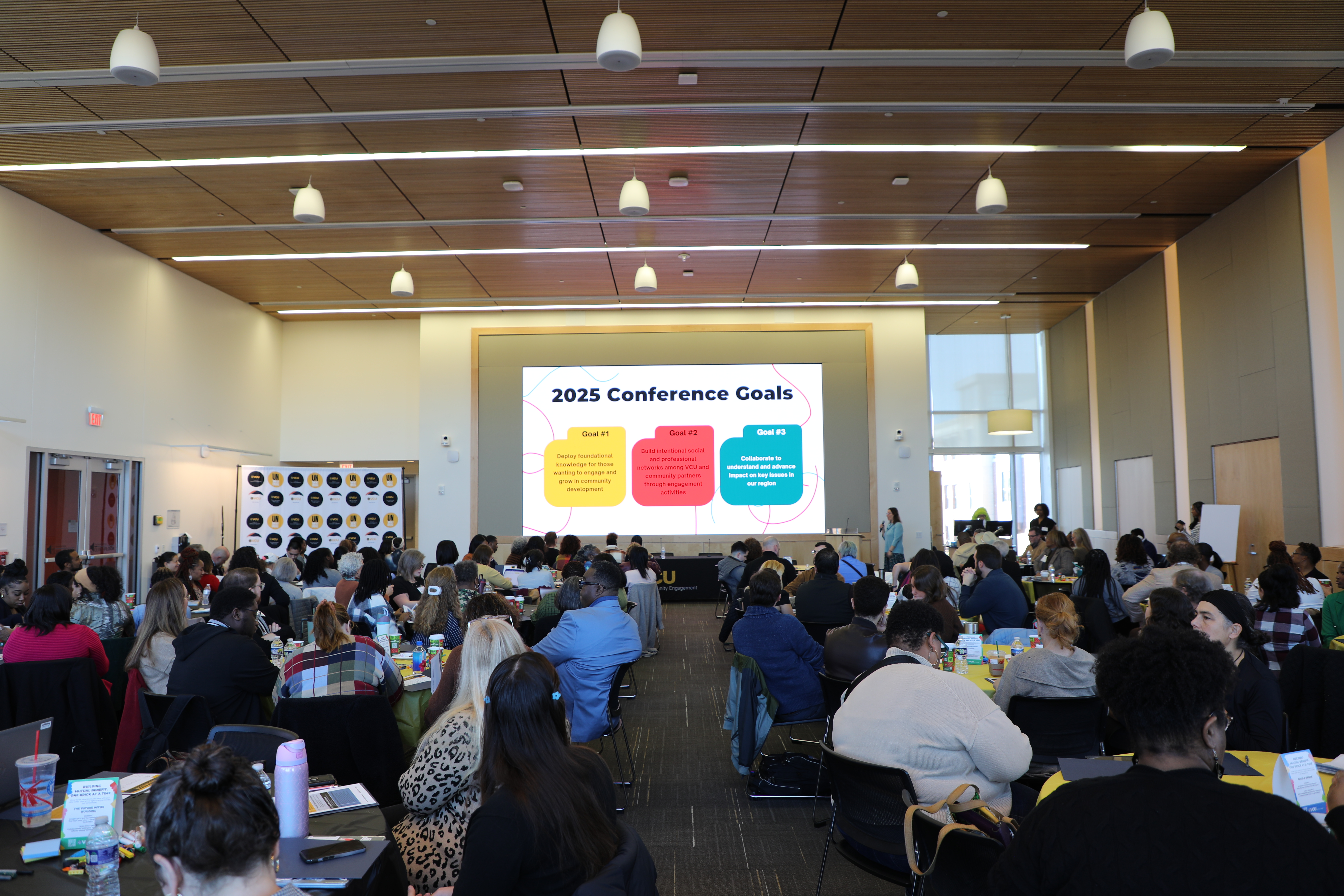 A crowd looking at a huge screen