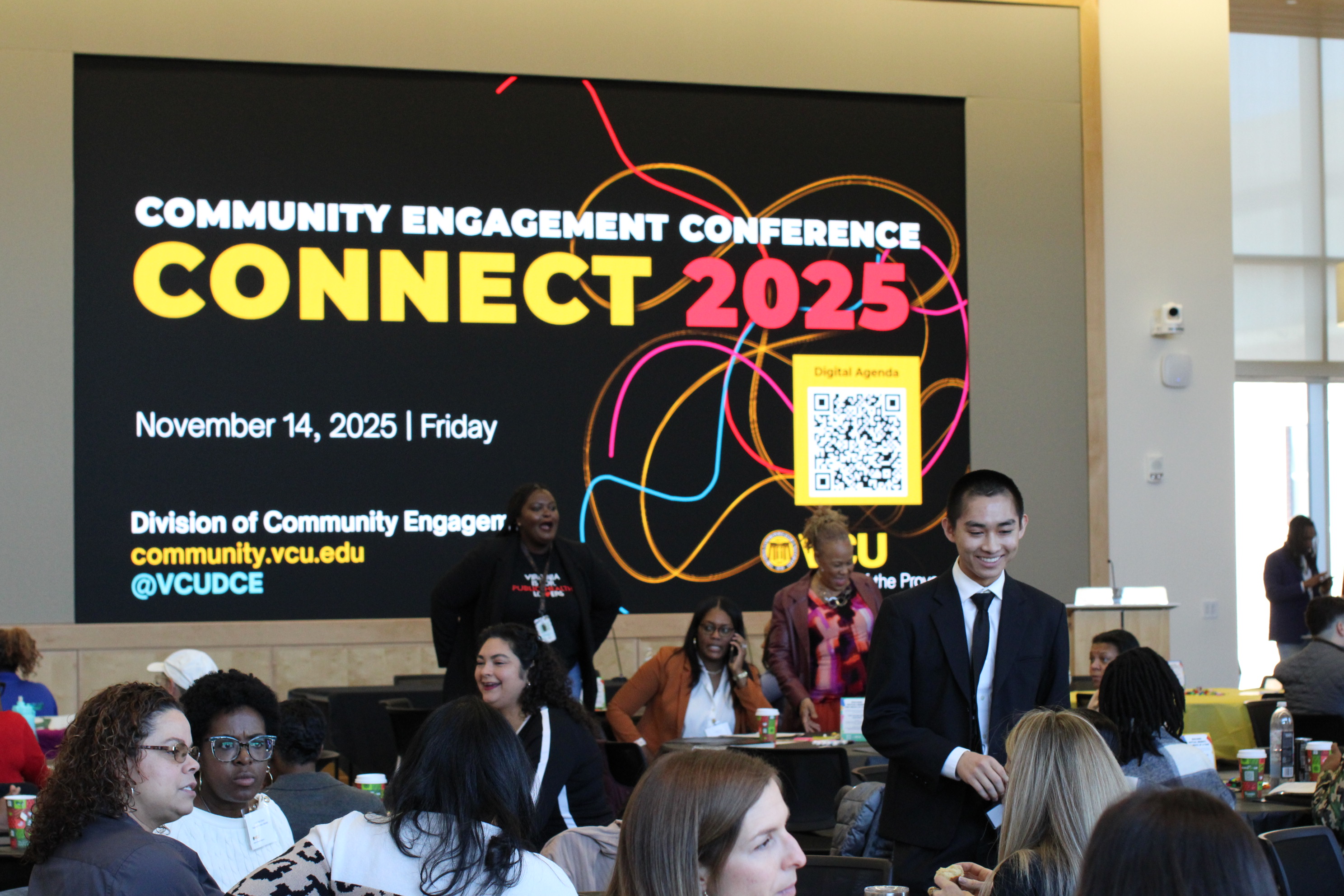 a group of people looking at a screen