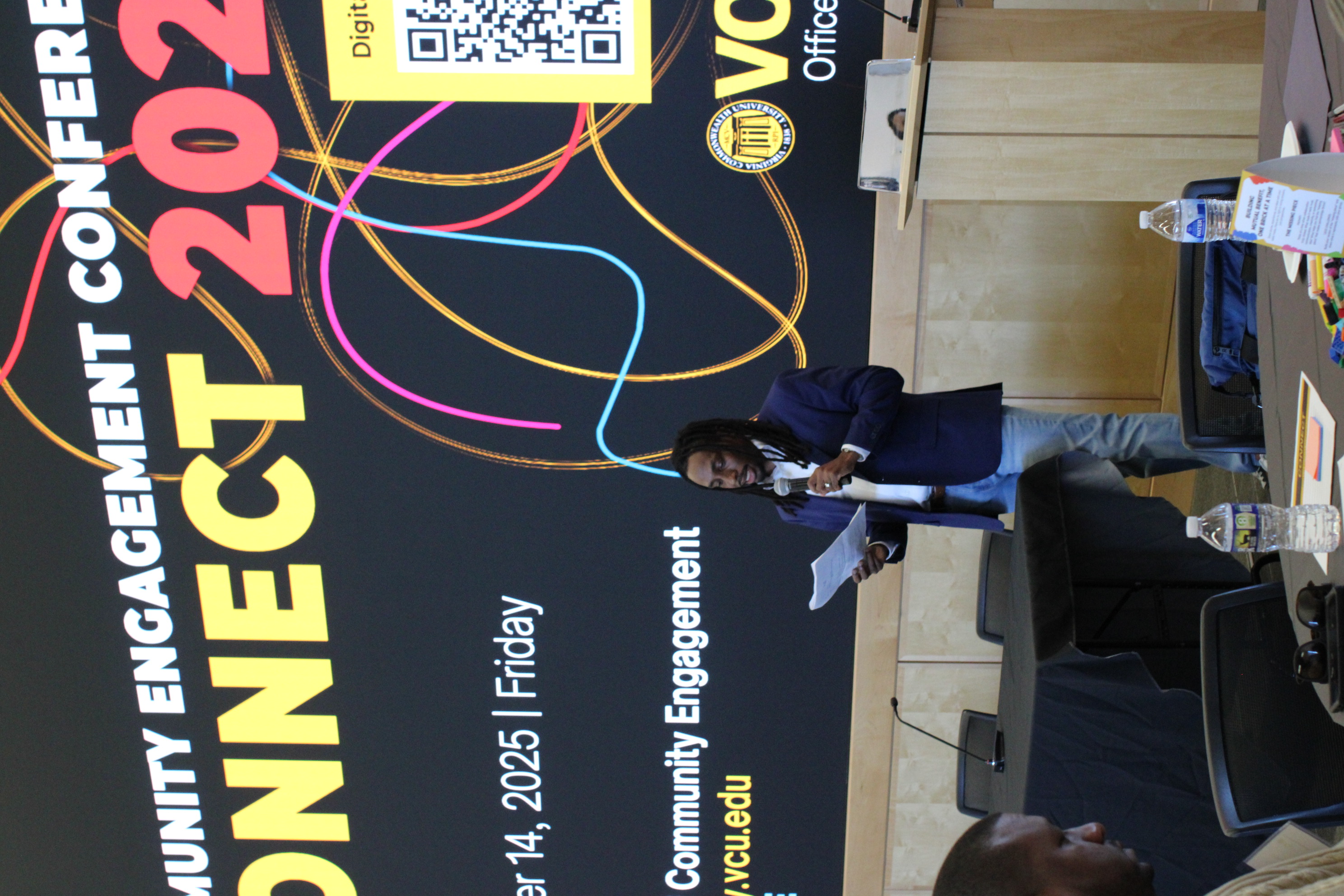 someone talking in front of a crowd