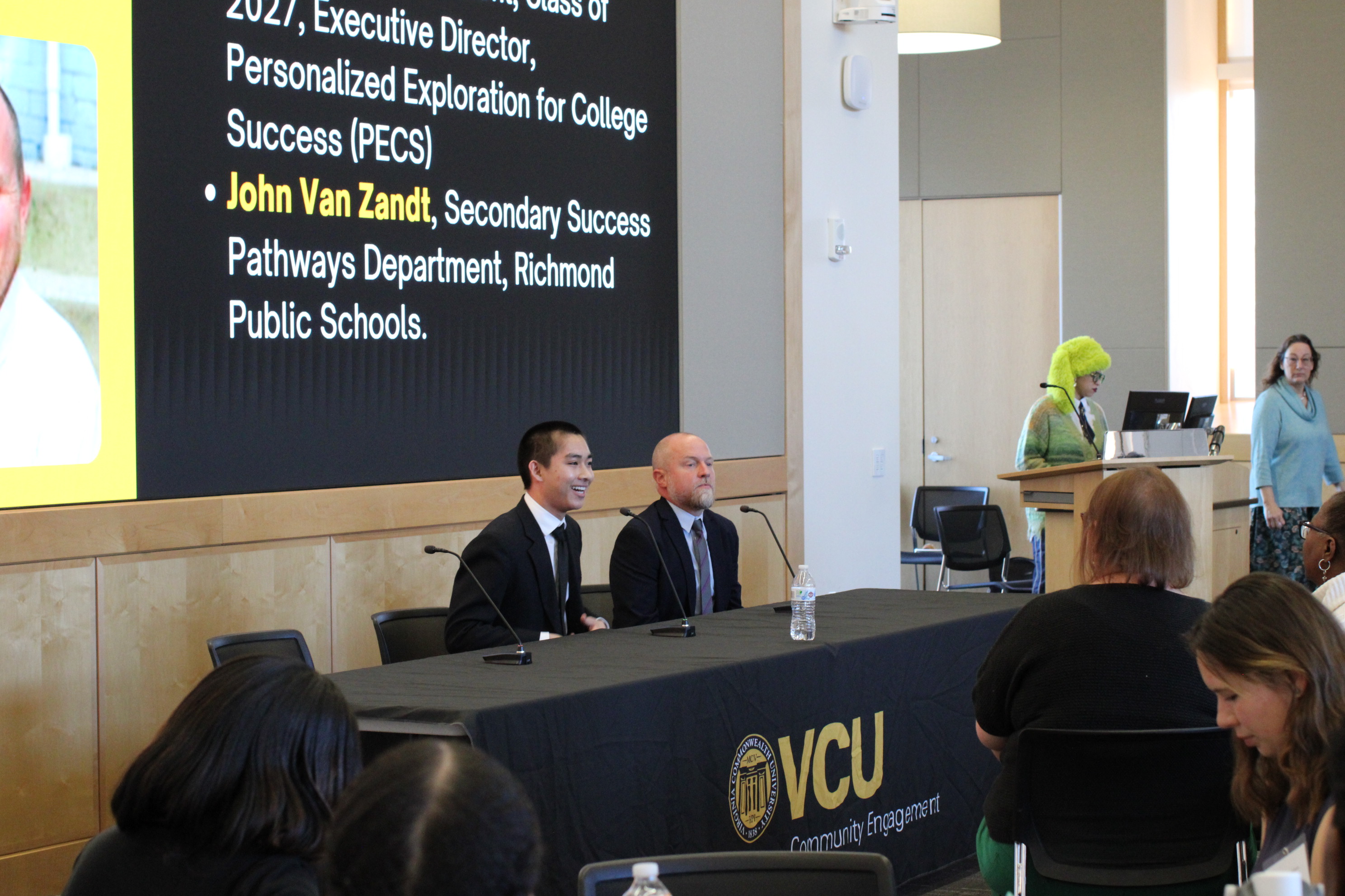 Two people talking on at a table