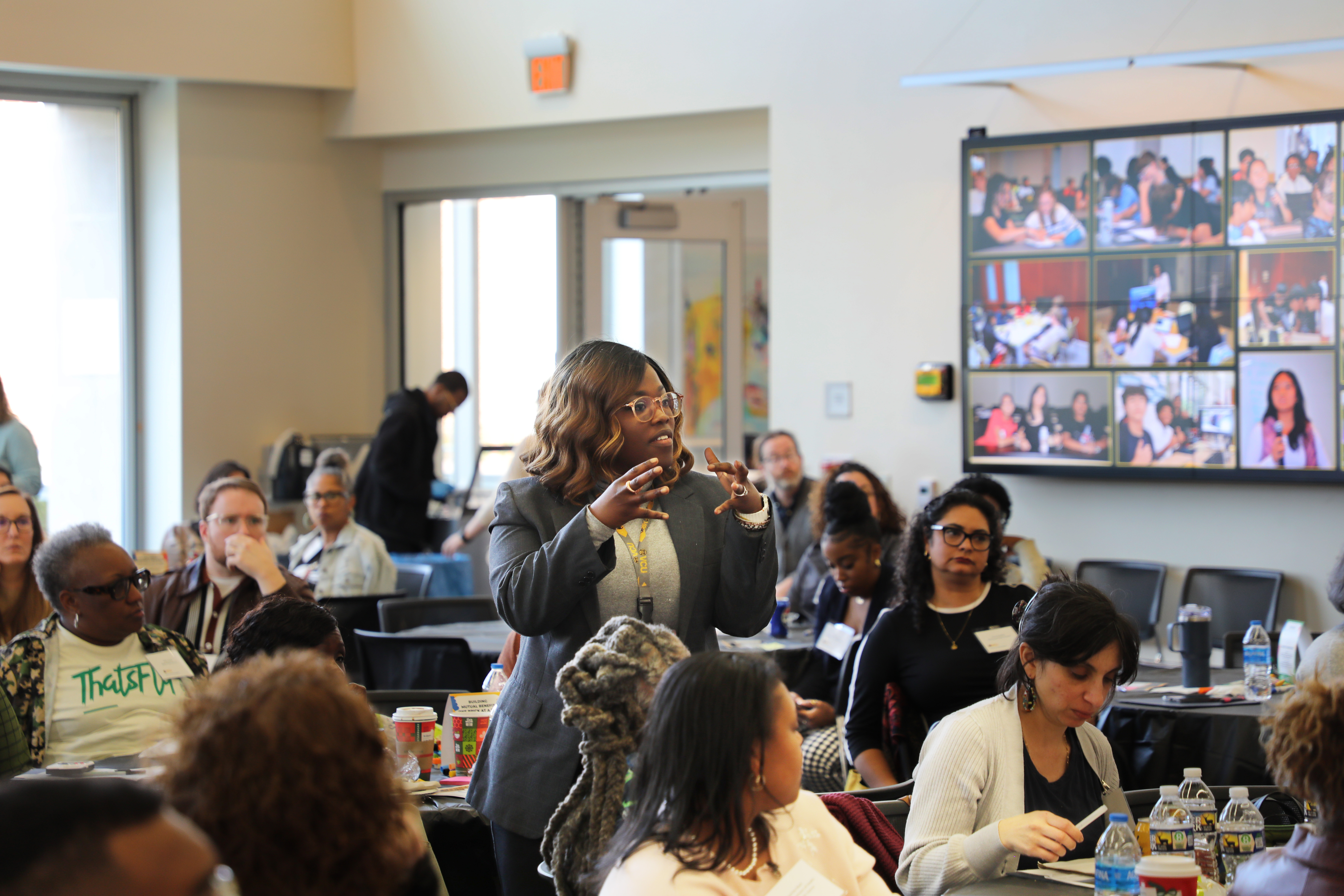 a woman standing and speaking during the connect conference