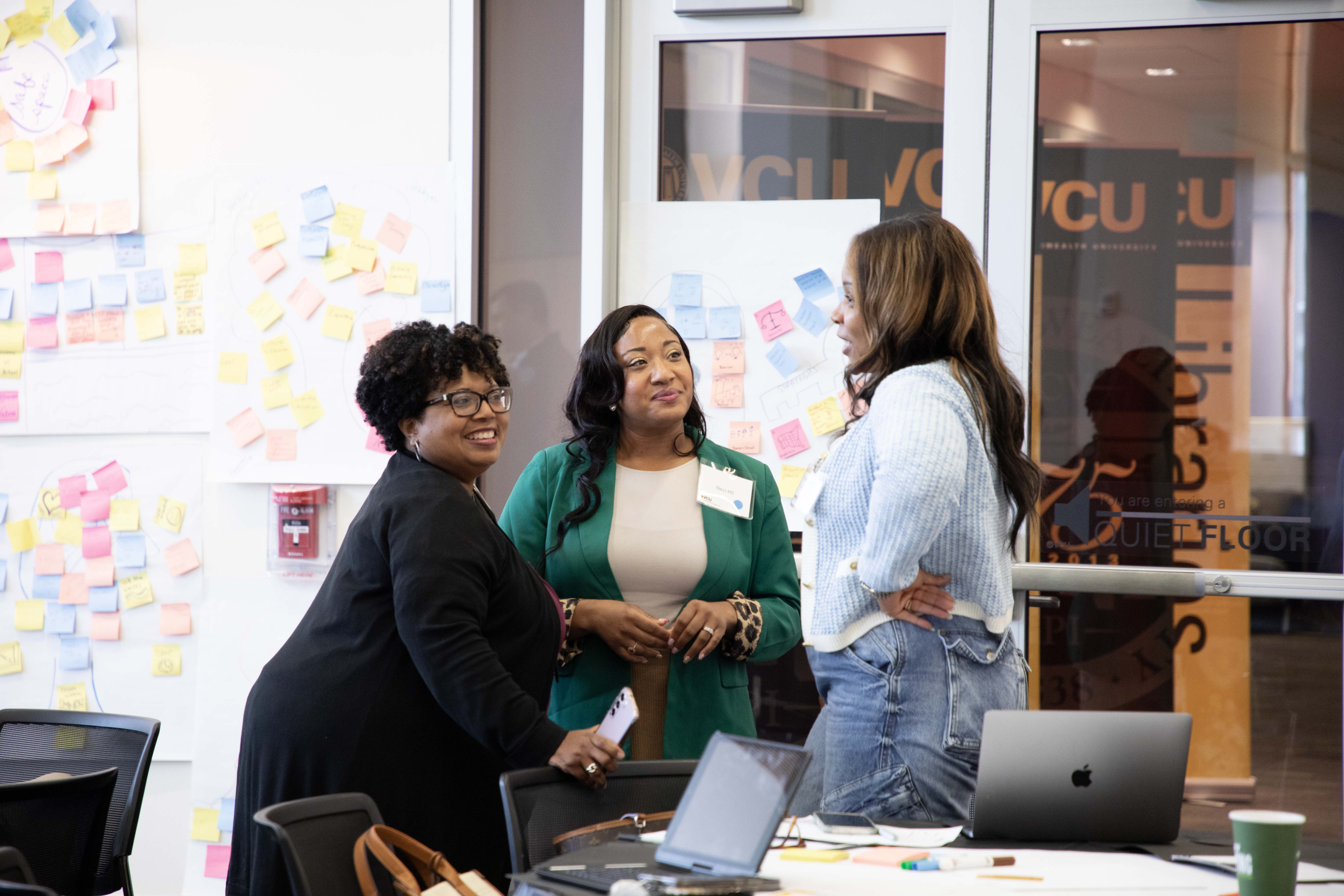 A group of women talking at a conference