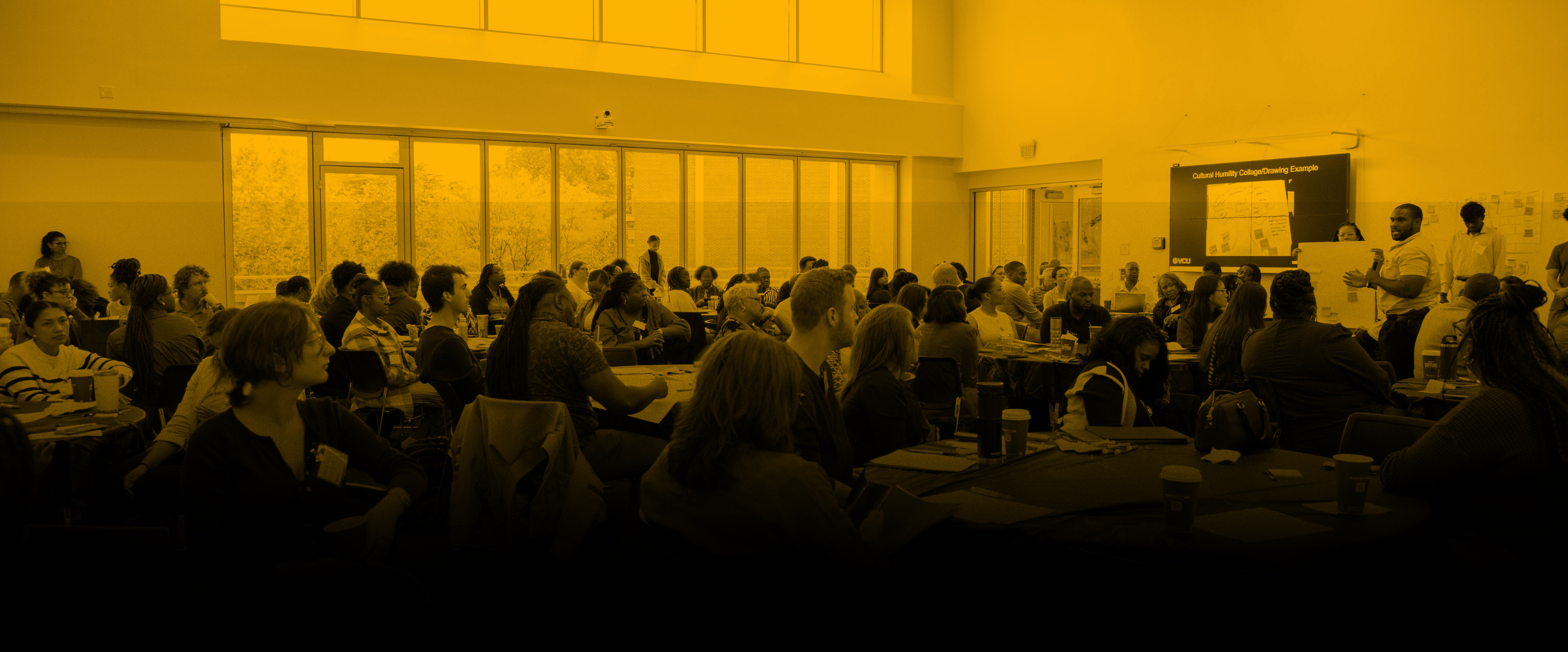 People sitting at tables at connect conference with a yellow and black overlay effect