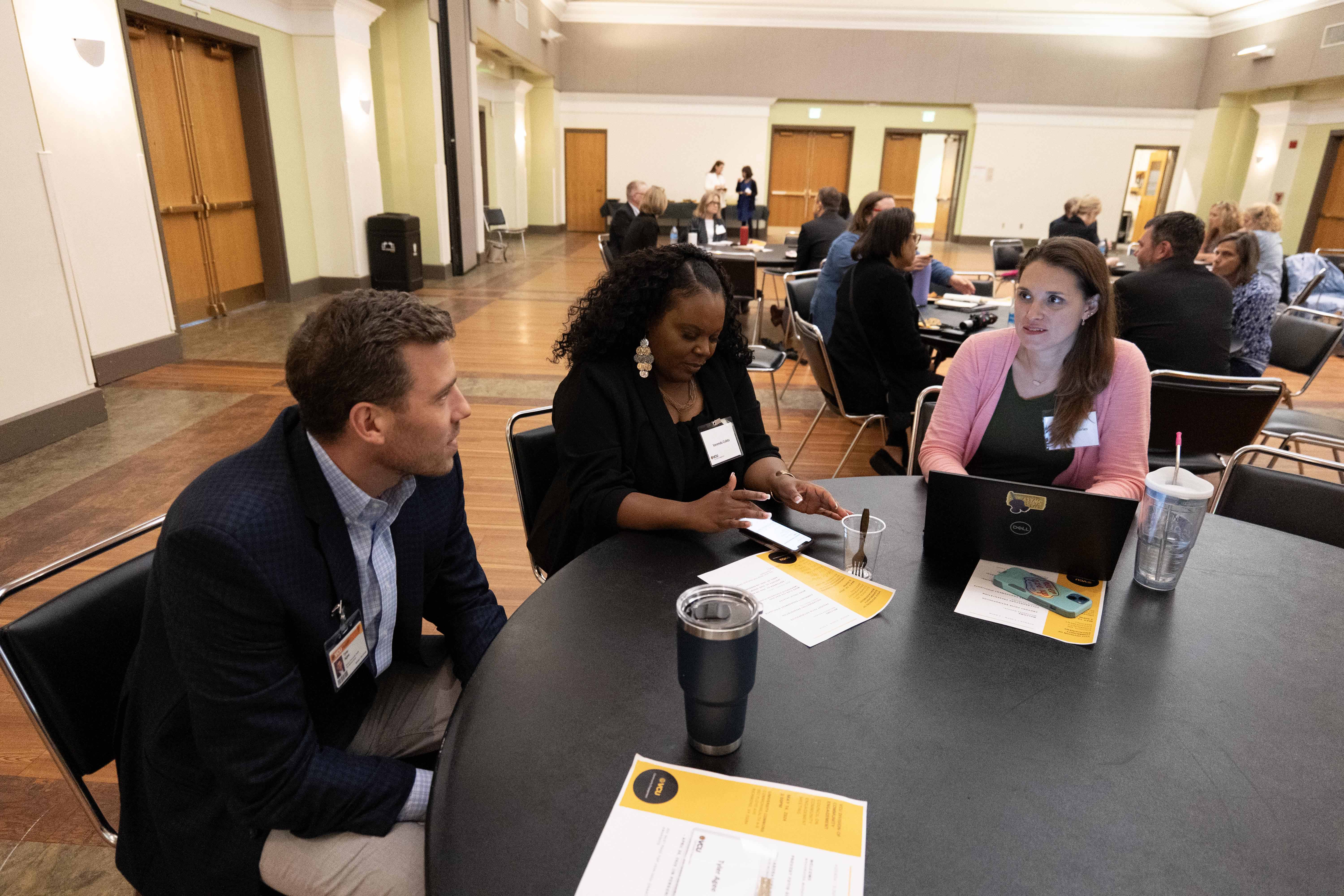 group of people sitting at a table discussing plans for partnership workgroup